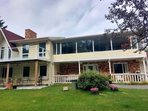 a large house with windows and a lawn at Green Village in Calgary
