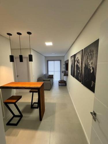 una sala de estar con una mesa y un sofá en Lindo e novo apartamento, en Santana do Livramento