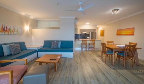 a living room with a couch and a table at Whitsunday Apartments in Hamilton Island