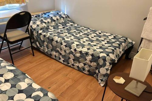 a bed in a room with a table and a chair at Whole House Fair Price Great Amenities in Richmond Hill