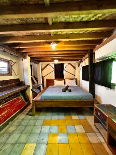 a bedroom with a bed in an attic at Gili La Boheme in Gili Trawangan