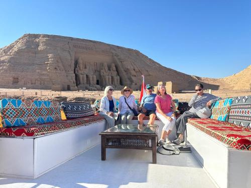 a group of people sitting on couches in front of thearaoharaoharaoharaoh at Karma Kono in Abu Simbel