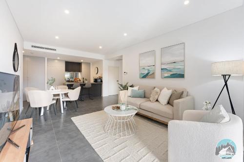 a living room with a couch and a table at Aircabin - Epping - Modern Comfy - 1 Bed Apt in Epping