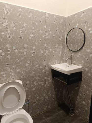 a bathroom with a toilet and a sink at D'Ebai Roomstay Kijal in Cukai
