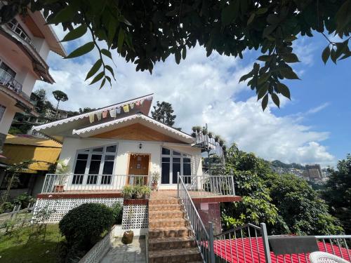 a house with stairs leading up to it at Bahar Retreat And Spa , Gangtok in Gangtok