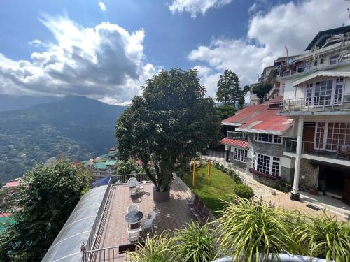 a view from the balcony of a building with a tree at Bahar Retreat And Spa , Gangtok in Gangtok