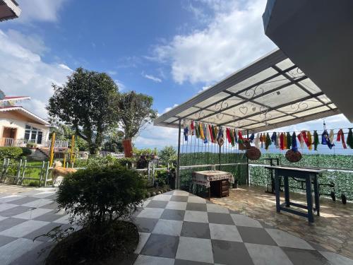 a patio with a tent and a table with flags at Bahar Retreat And Spa , Gangtok in Gangtok