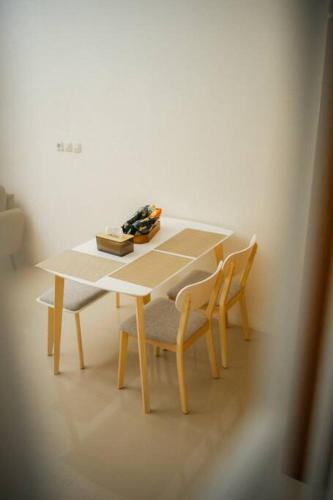 a wooden table with two chairs and a table and a table and chairsuggest at Bylina House in Batu