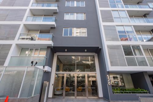 a building with glass doors in front of it at Skyliving Towers Apartments - Perú in Lima