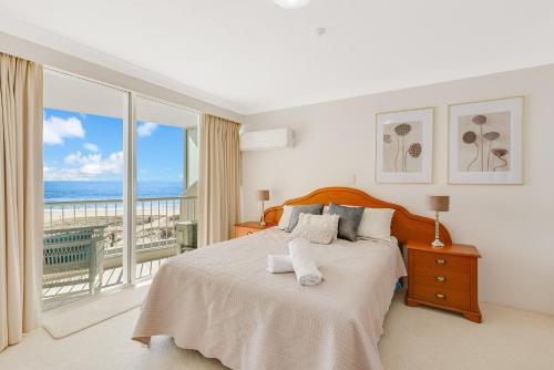 a bedroom with a bed with a view of the ocean at Meridian Tower Kirra Beach in Gold Coast