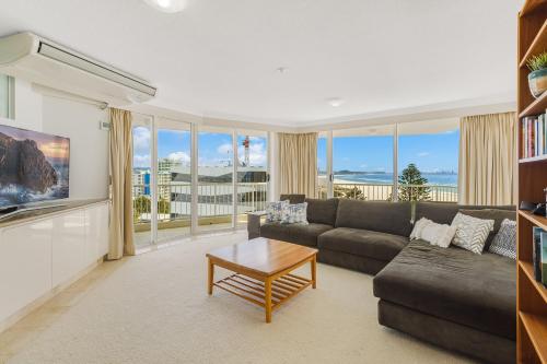 a living room with a couch and a table at Meridian Tower Kirra Beach in Gold Coast