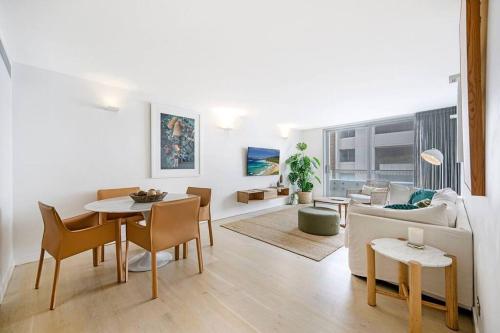 a living room with a table and a couch at Beach Front Urban 2 Bedrooms in Sydney