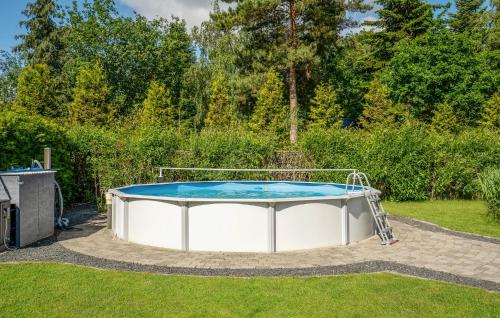 a trampoline in the grass in a yard at Lovely Home In Ørsted With Wifi in Ørsted