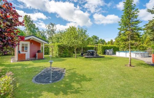 a yard with a barbecue grill and a house at Lovely Home In Ørsted With Wifi in Ørsted