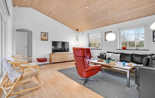 a living room with a couch and a table at Lovely Home In Ørsted With Wifi in Ørsted