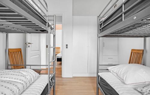 two bunk beds in a room with white walls at Lovely Home In Ørsted With Wifi in Ørsted