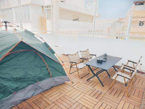 a patio with a tent and a table and chairs at Fivehouse Silom2 soi11 City heart Silom BTS 7min in Bang Rak