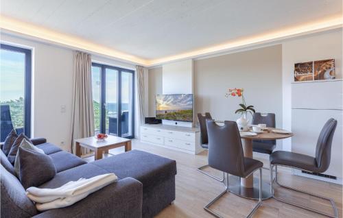 a living room with a blue couch and a table at Prince in Binz