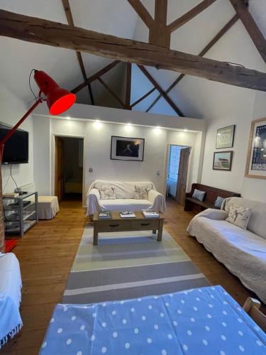 a living room with a couch and a table at 300 year old barn conversion in Retford