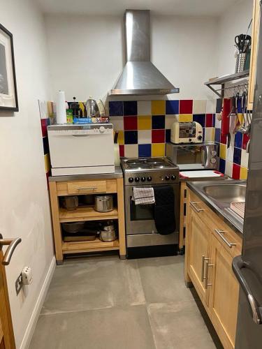 a kitchen with a stove top oven in a kitchen at 300 year old barn conversion in Retford