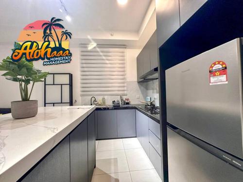 a kitchen with a white counter and a refrigerator at Urban Suite Modern Lifestyle Seaview Georgetown in Jelutong