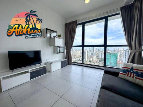 a living room with a tv and a large window at Urban Suite Modern Lifestyle Seaview Georgetown in Jelutong