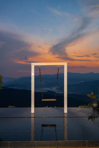 a swing in the middle of a pool of water at Rice View Lodge in Longsheng