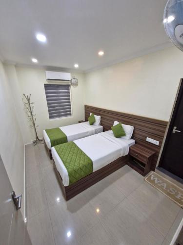 Katil atau katil-katil dalam bilik di Muziris Manor Residency