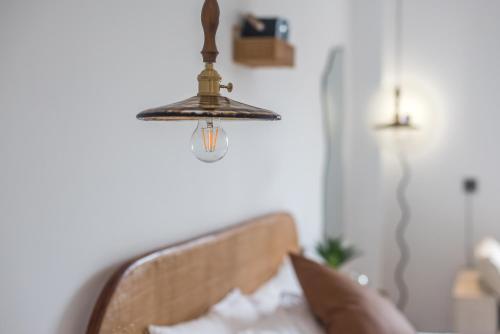 a chandelier hanging over a bed in a room at Quanzhou West Street Kaiyuan Temple Bandiao Inn in Quanzhou