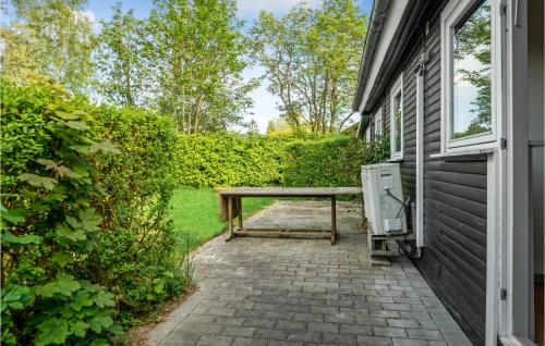 a picnic table on a patio next to a building at 2 Bedroom Amazing Home In Jægerspris in Jægerspris