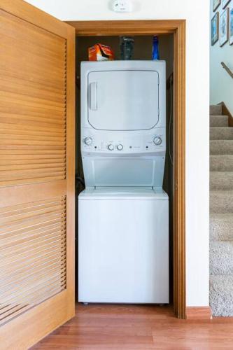 a microwave oven sitting on top of a refrigerator at Cannon Beach Condo Ocean Views ! Close to Beach! in Cannon Beach
