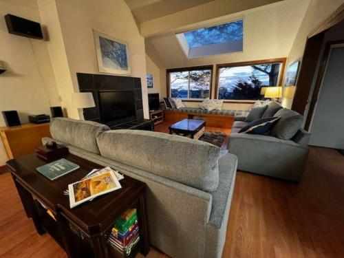 a living room with a couch and a tv at Cannon Beach Condo Ocean Views ! Close to Beach! in Cannon Beach