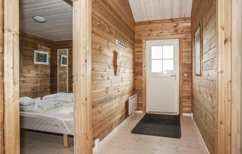 a bedroom with a bed in a wooden wall at Holiday Home Ravnholt F in Eskebjerg
