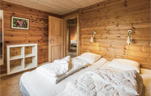 a bedroom with a bed in a wooden wall at Holiday Home Ravnholt F in Eskebjerg