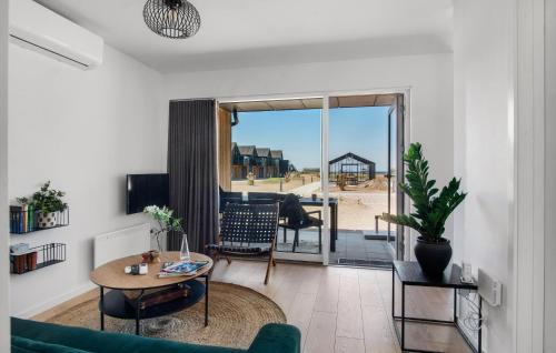 a living room with a couch and a table at Havnehusene, Lejl 61 in Engvang