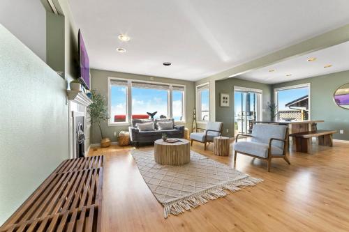 a living room with a couch and a table at SANDY POINT 6 BEDS 3 BATHS BEACH HOUSE WITH AMAZING VIEWS in Ferndale