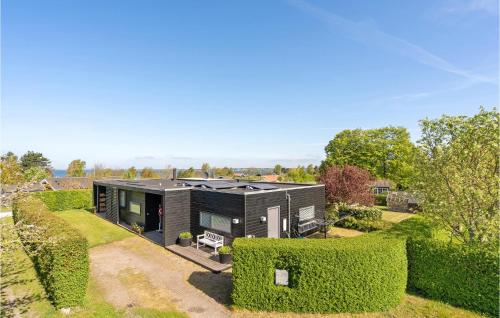 an image of a black house with hedges at Holiday Home Stubbekobing With Fireplace I in Ore