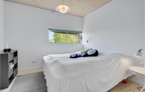 a bedroom with a bed with two stuffed animals on it at Holiday Home Stubbekobing With Fireplace I in Ore