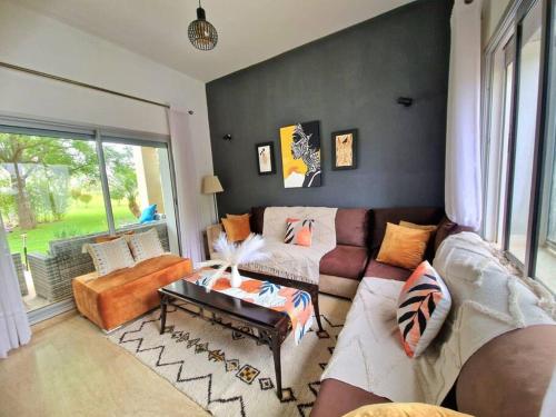 a living room with a couch and a table at Villa Joudia Royal Golf Fes in Fès