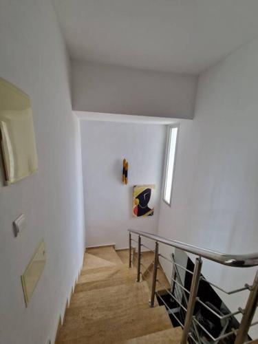 a staircase in a room with a white wall at Villa Joudia Royal Golf Fes in Fès