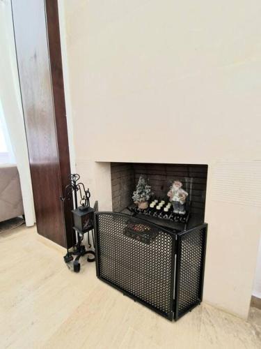 a living room with a fireplace and a chair at Villa Joudia Royal Golf Fes in Fès