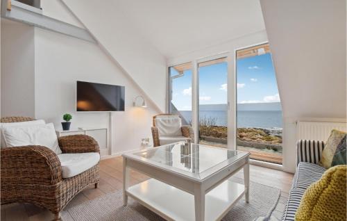 a living room with a view of the ocean at Awesome Apartment In Allinge in Allinge