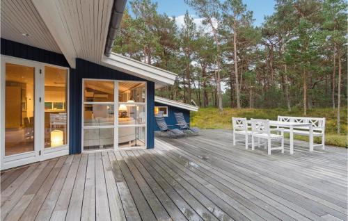 a wooden deck with chairs on a house at Stunning Home In Nexø With Kitchen in Vester Sømarken