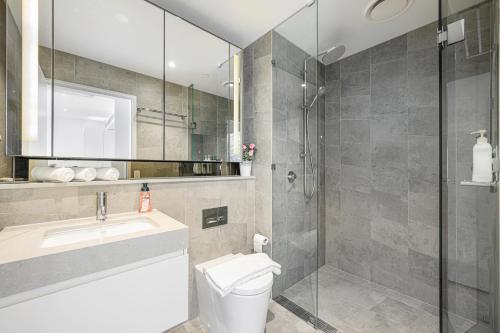 a bathroom with a toilet and a sink and a shower at ChinatownICCHaymarket Adorable 2Br Apt at CBD in Sydney