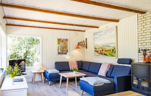 a living room with a couch and a table at Amazing Home In Nexø With Kitchen in Neksø