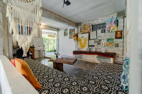 a room with a bed and a table in it at The Onion Collective in Ubud