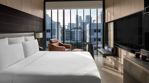a hotel room with a bed and a large window at InterContinental Singapore Robertson Quay by IHG in Singapore