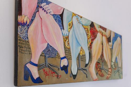 a painting of a group of people holding umbrellas at The Onion Collective in Ubud