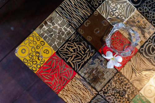 a table topped with different colored ties with a flower at The Onion Collective in Ubud
