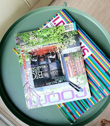 a magazine sitting on top of a green plate at Midtown Duplex Ratchayothin in Bangkok